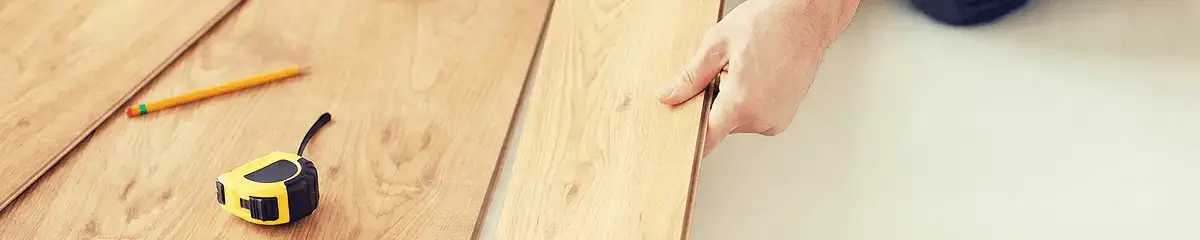 A professional installing wood flooring in Memphis, TN