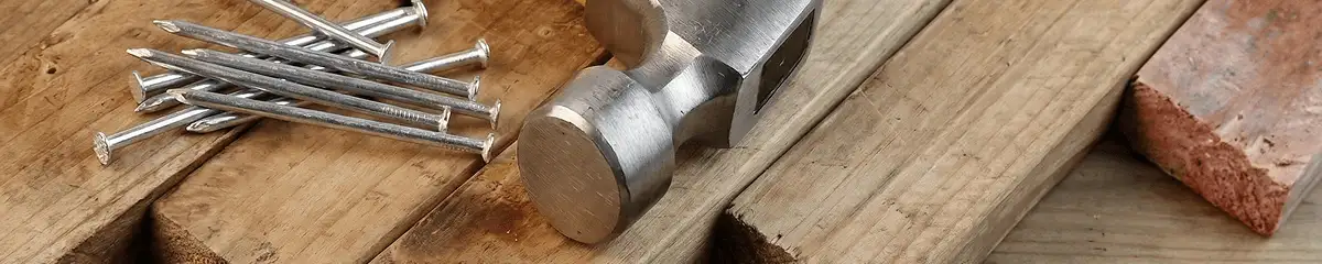 Hammer and nails on hardwood flooring boards in Memphis, TN
