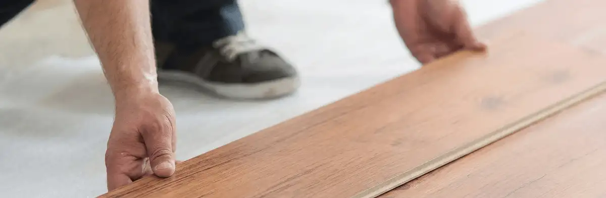 A professional installing laminate flooring in Memphis, TN