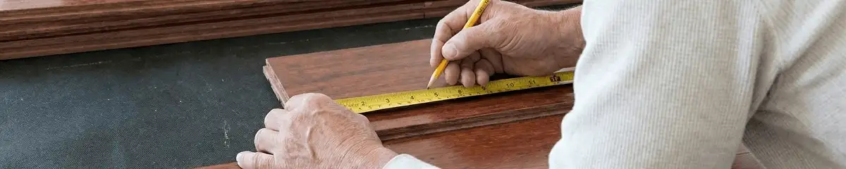 A professional installing wood flooring in Memphis, TN